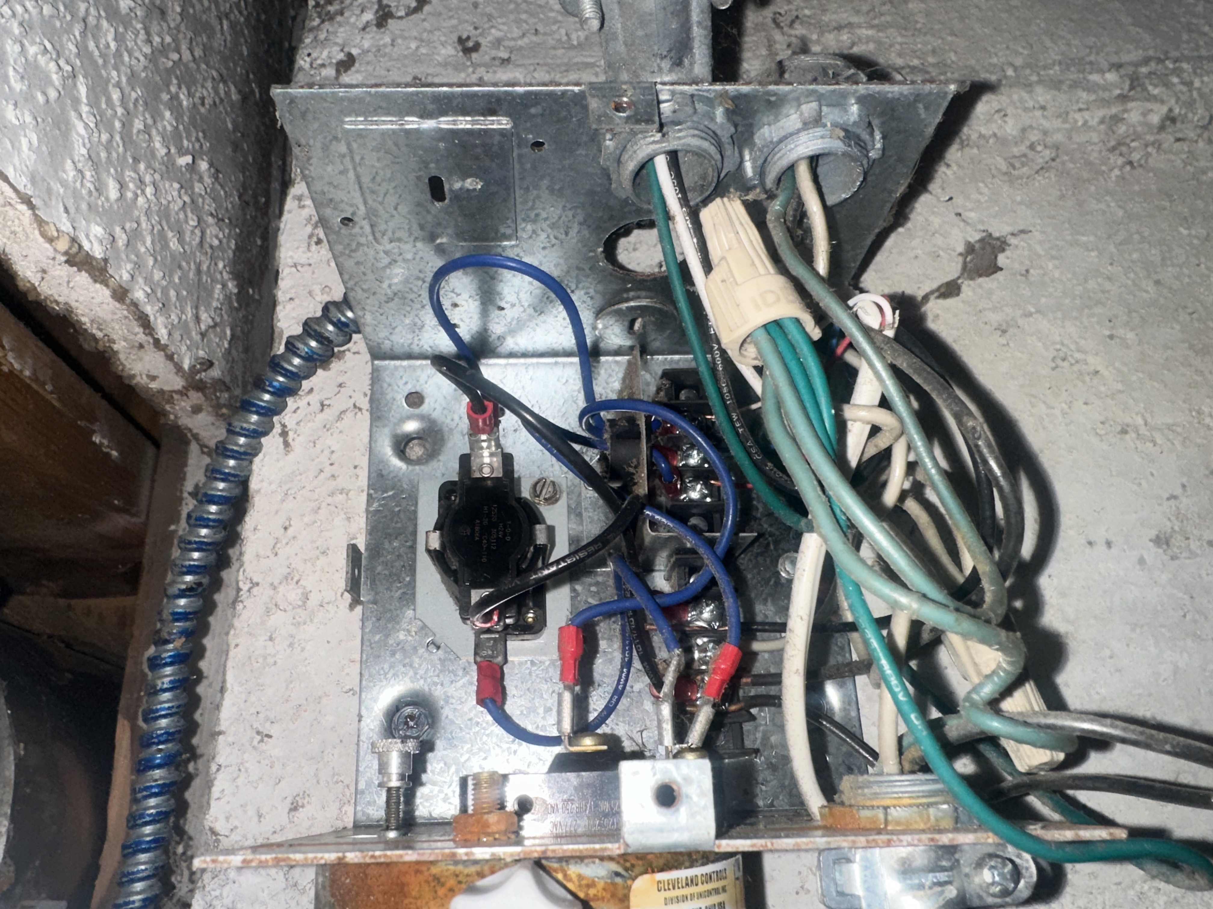 Garage door opener electrical wiring and junction box during professional repair service
